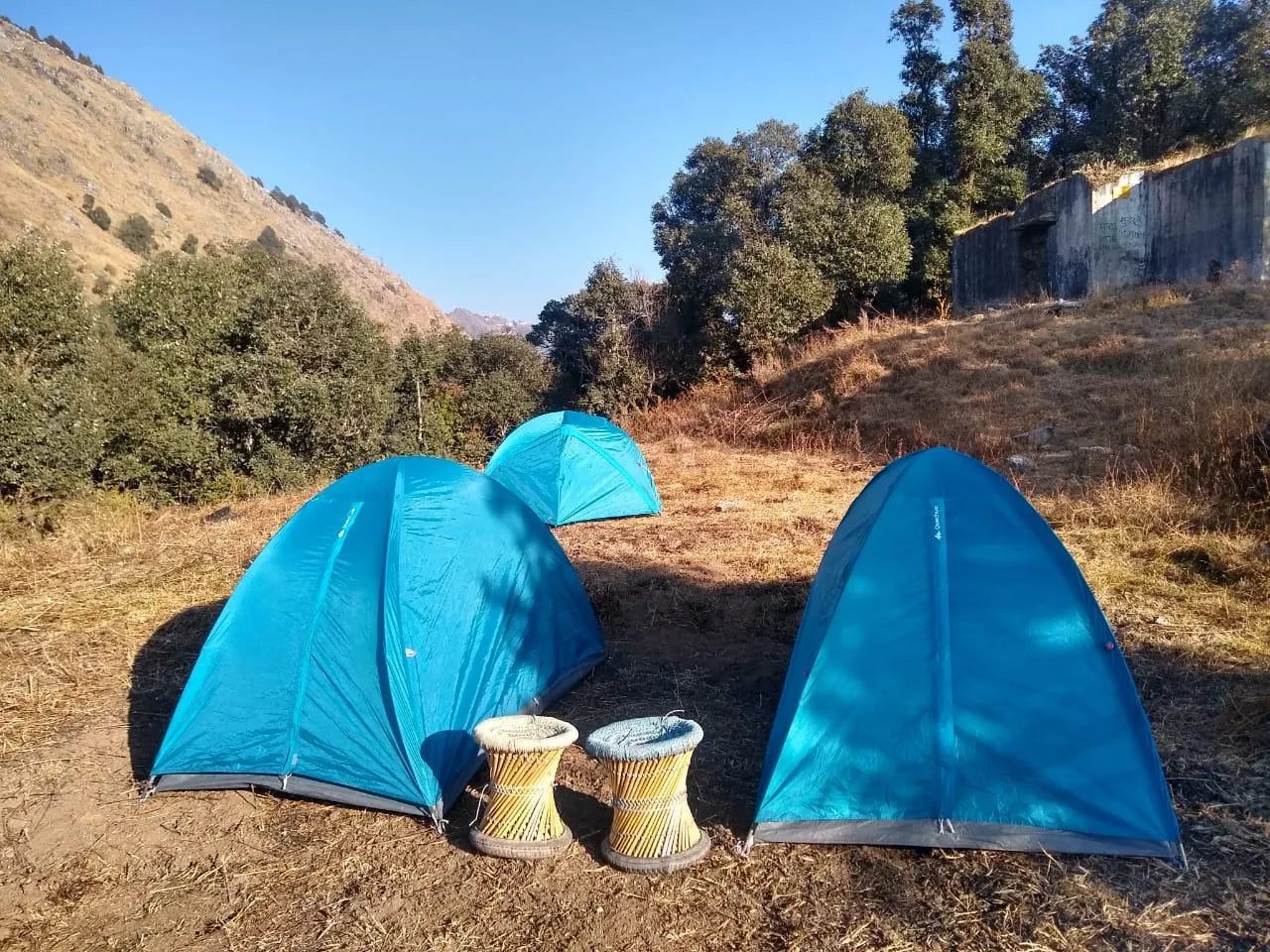 Blue tents with drums on hillside
