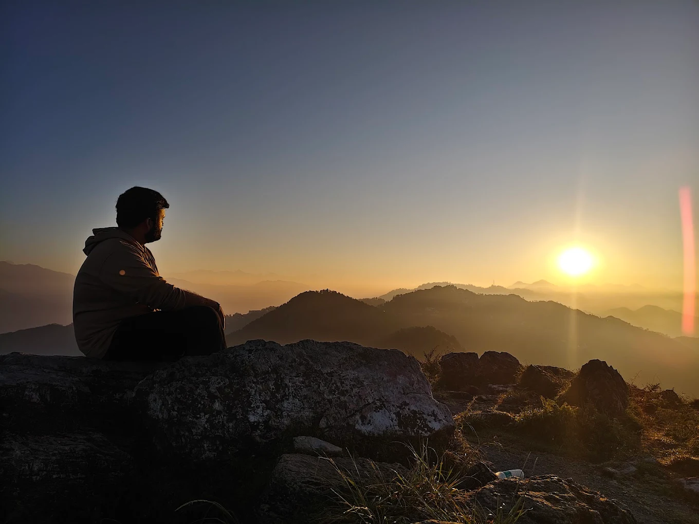 Person on rock watching sunrise