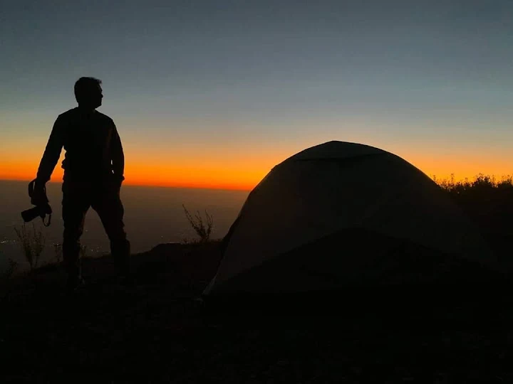Silhouette with tent at sunset