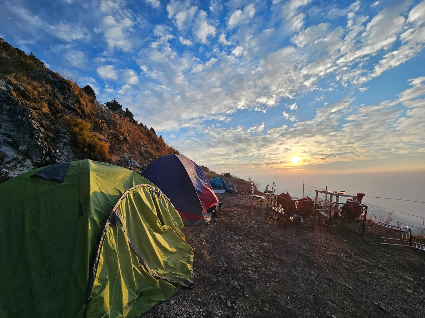 Tents at sunset with dramatic clouds