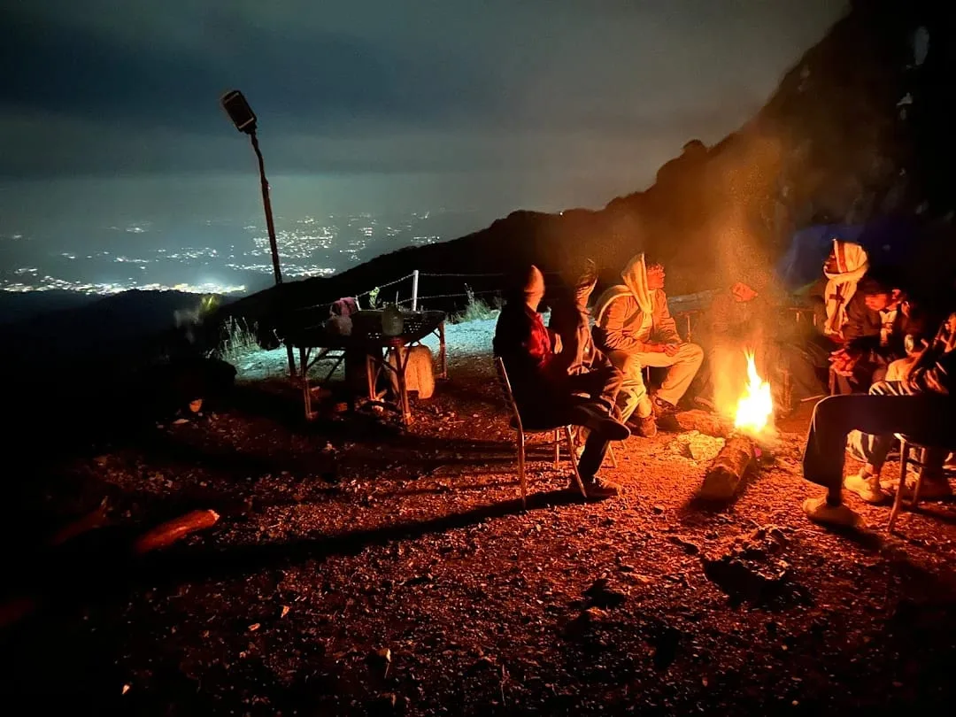 Bonfire at night with city lights view