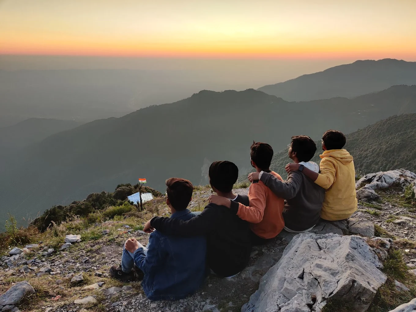 Friends watching sunset at George Everest summit