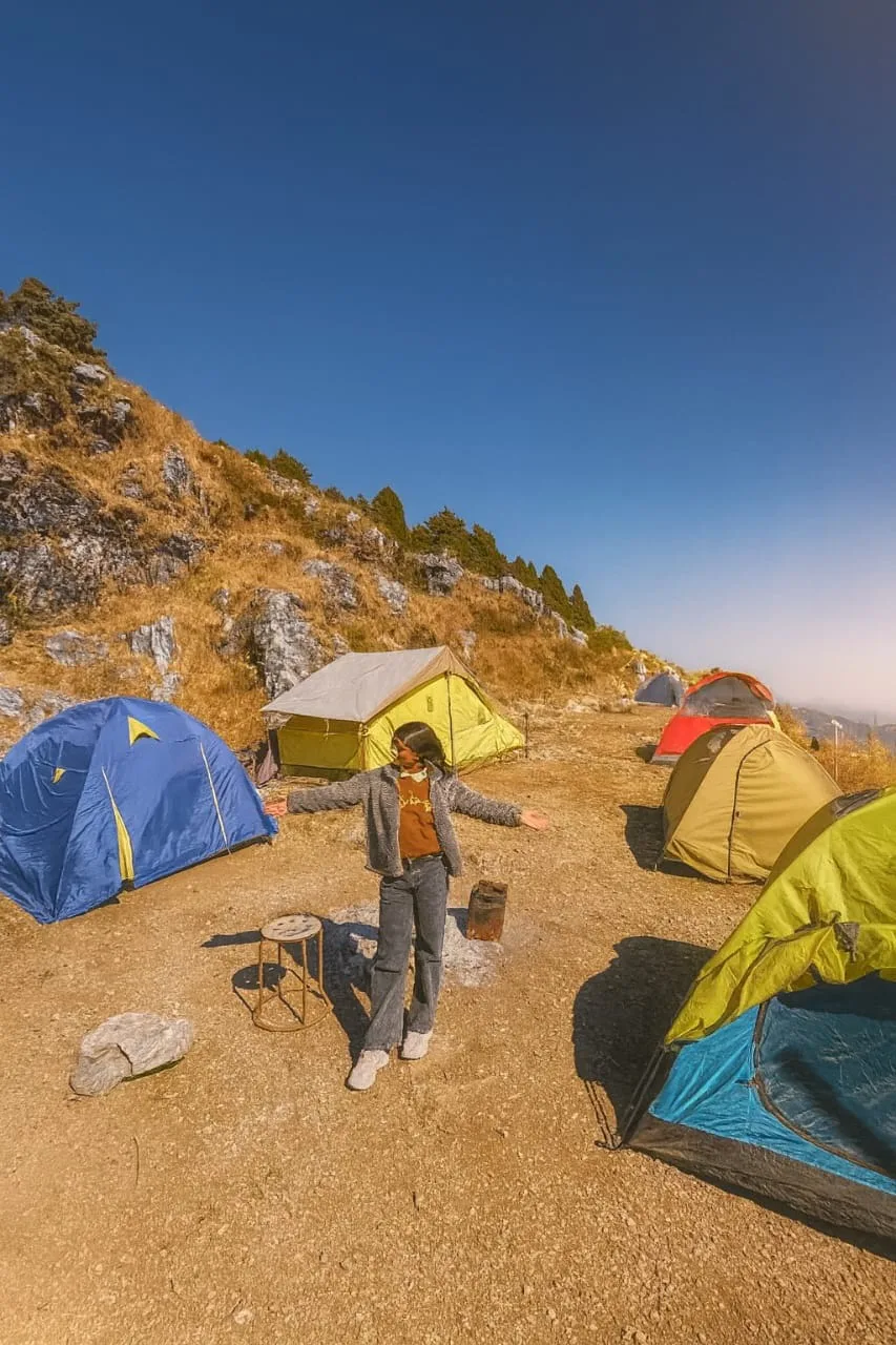 Girl posing among colorful tents