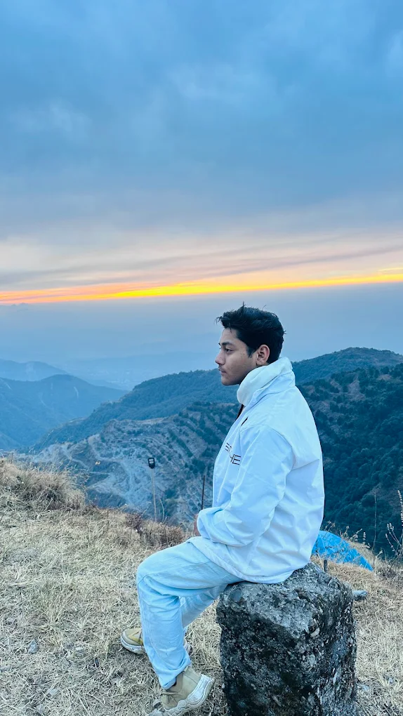 Person on rock at sunset